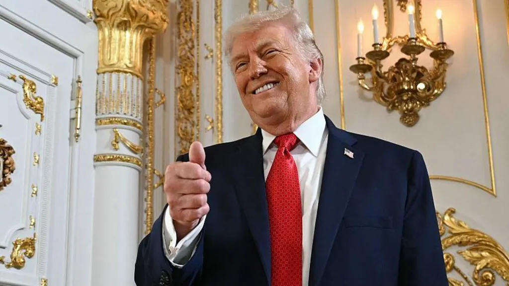 US President Donald Trump gives a thumbs up as he arrives at a dedication ceremony for Southern Boulevard, in the ballroom at Mar-a-Lago in Palm Beach, Florida, on January 16, 2026.