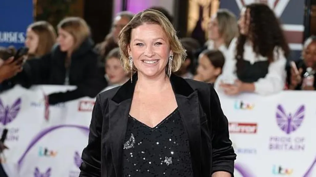 Page at the TV Choice Wards. She's smiling at the camera and is wearing large sparkly earrings, a black sparkly top and black blazer jacket.  Her dark blonde hair is cut in a bob.