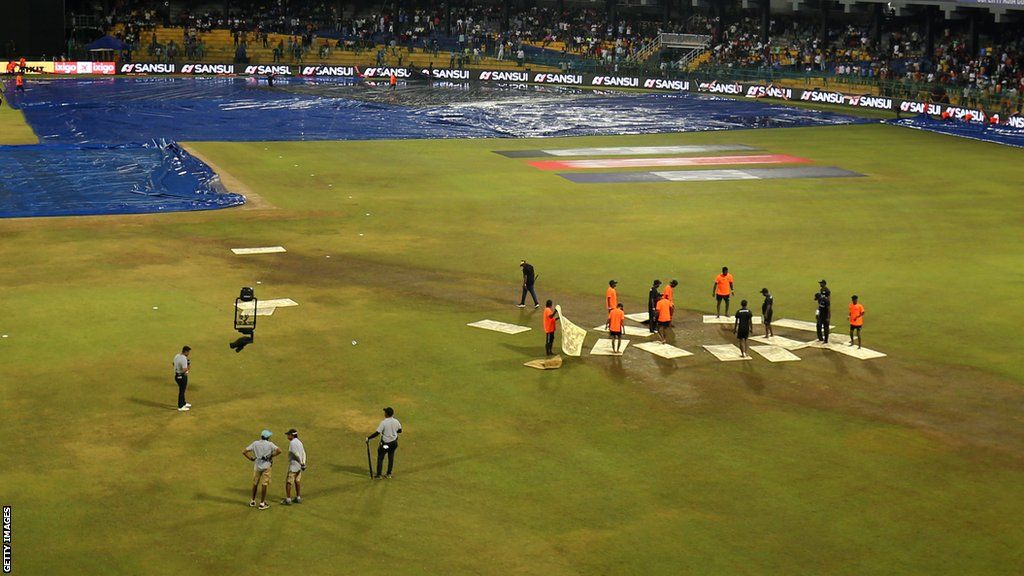 Members of the groundstaff at the R. Premadasa Stadium in Colombo attempted to dry the outfield with towels