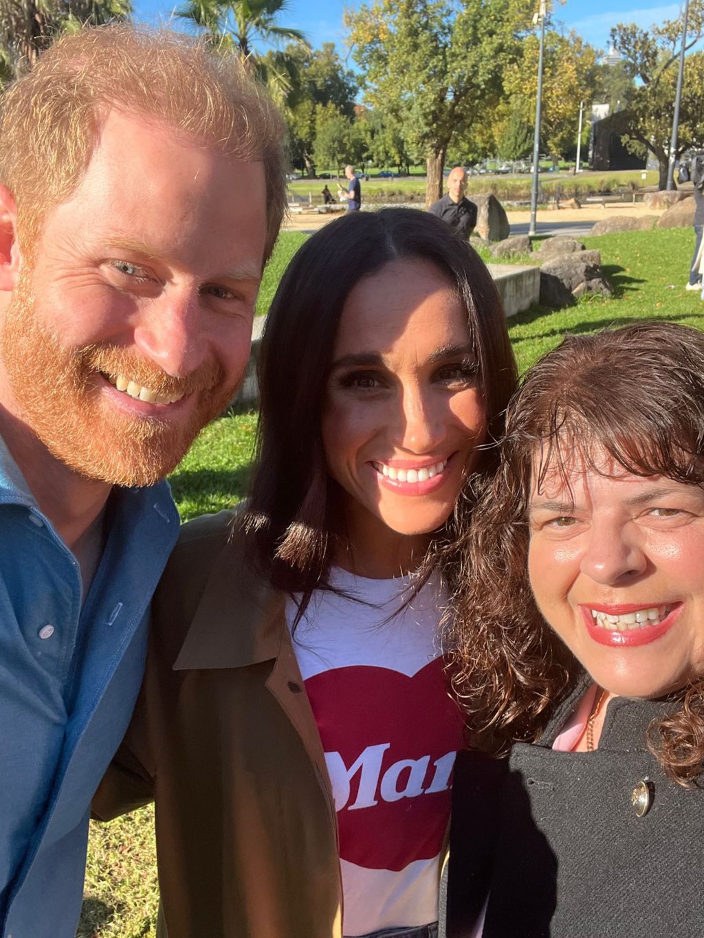 Prince Harry and Meghan Markle smile in a selfie with an Australian member of the public.