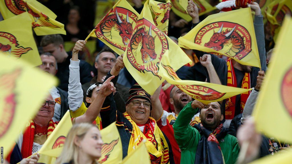 Catalans Dragons fans wave their flags at Old Trafford in the 2021 Grand Final