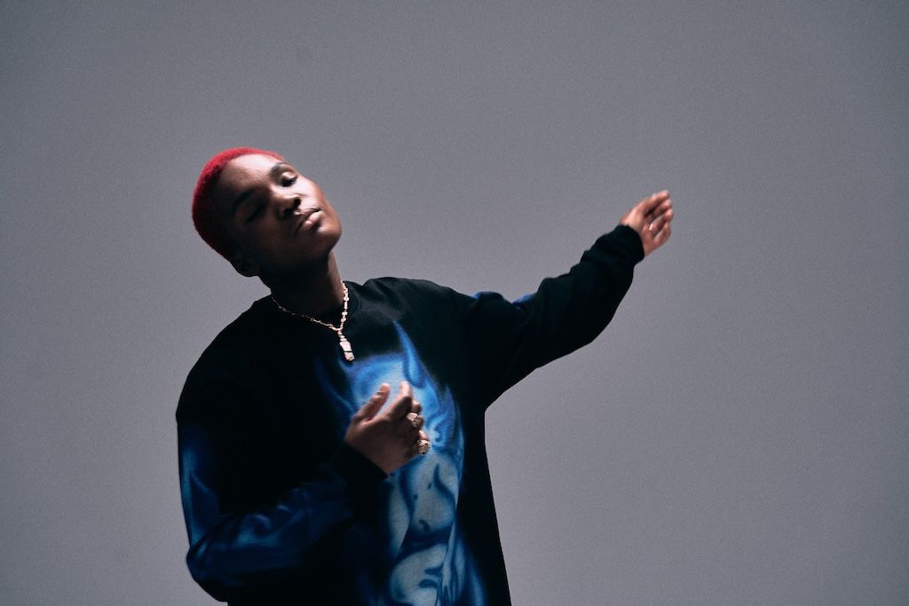 Arlo Parks closes her eyes and dances to a piece of music, in a promotional shot for her new album, Ambiguous Desire