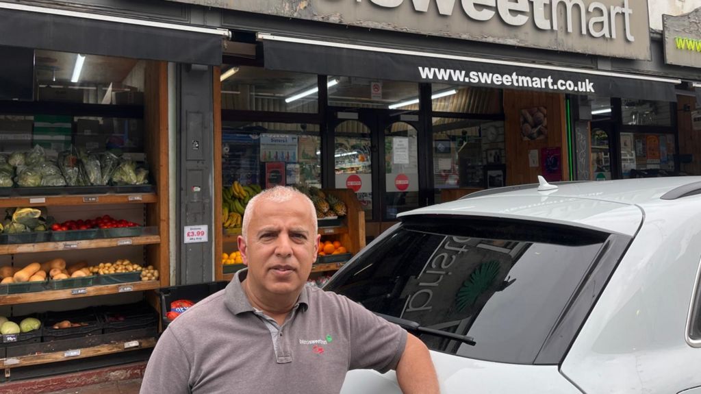 Rashid Majothi stands in front of his shop Bristol Sweet Mart 