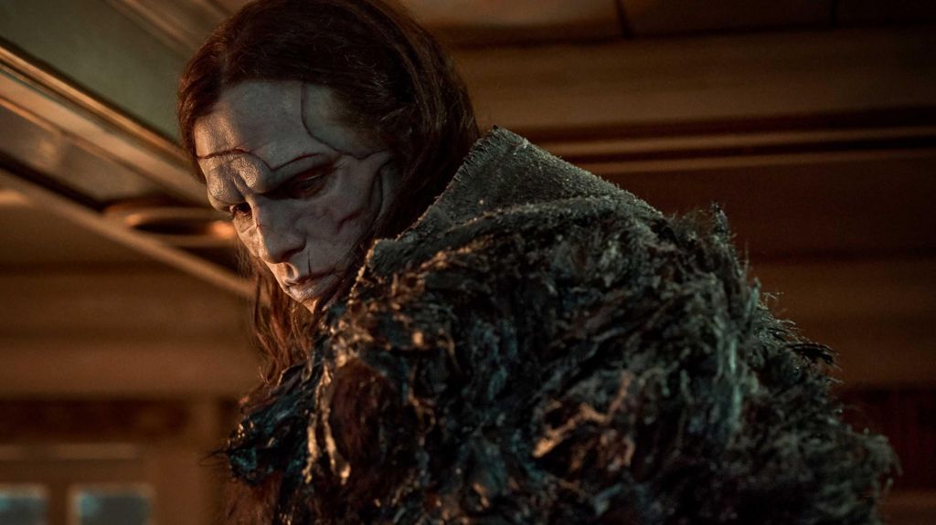 Jacob Elordi with long hair and scars on his face as Frankenstein's monster