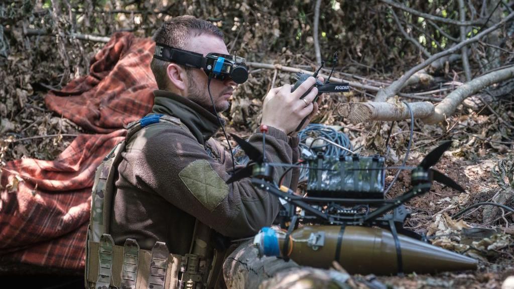 A Ukrainian soldier pilots a drone