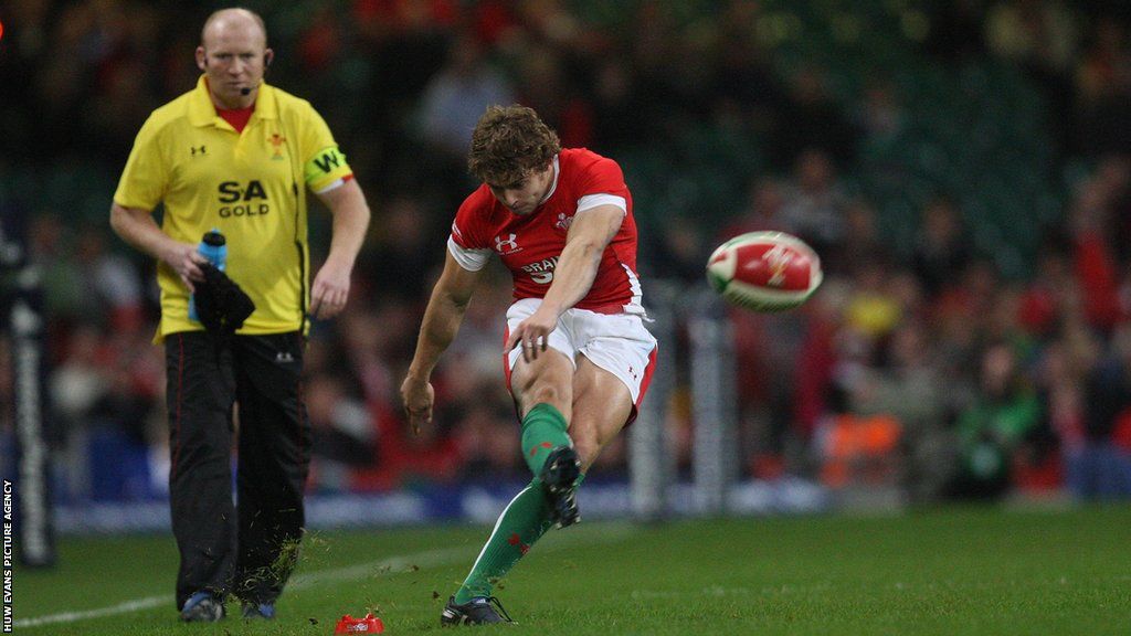 Leigh Halfpenny kicking at goal in 2011 with Neil Jenkins watching on