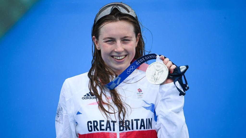 Georgia Taylor-Brown celebrates with her Olympic silver medal