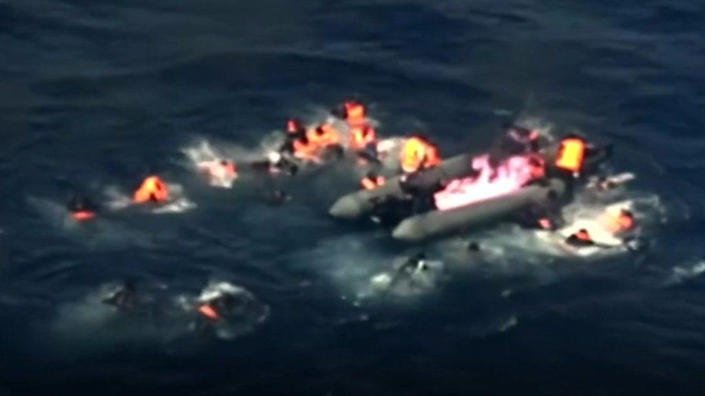 A migrant boat on fire.
