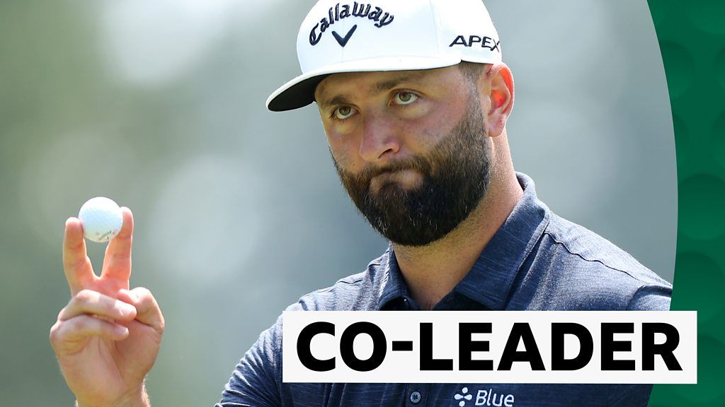 Rahm birdies 18th for opening round 65 to share lead