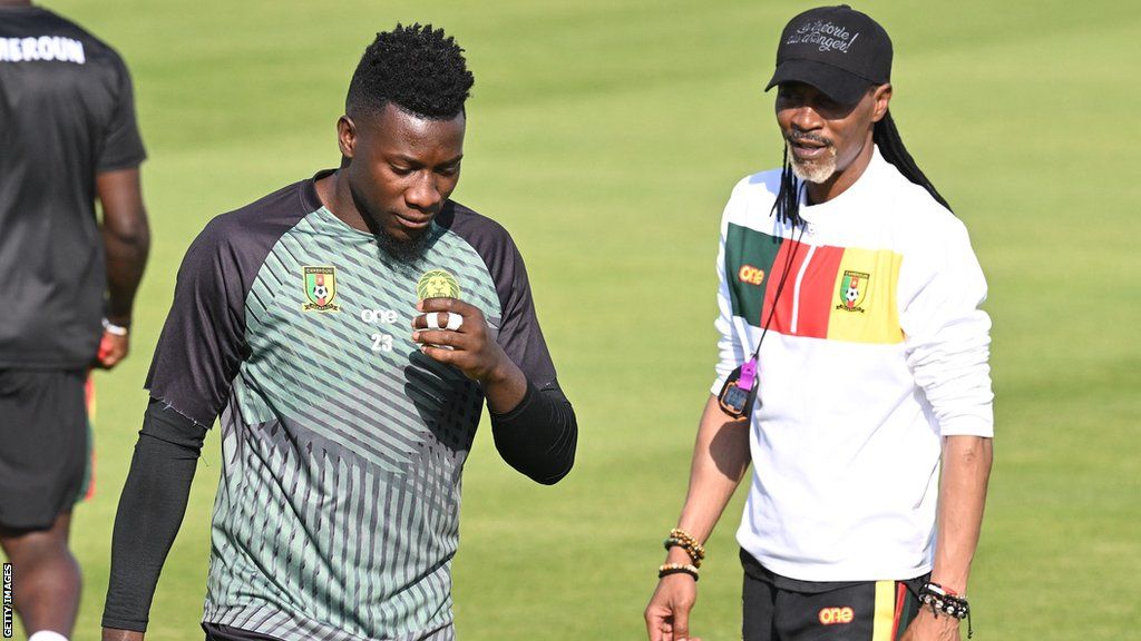 Rigobert Song and Andre Onana talk on the training pitch at the Qatar 2022 World Cup