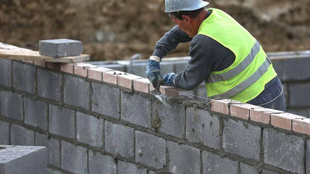 Bricklayer laying bricks