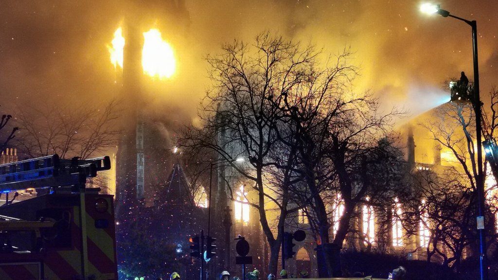 The top of the church is completely engulfed in flames