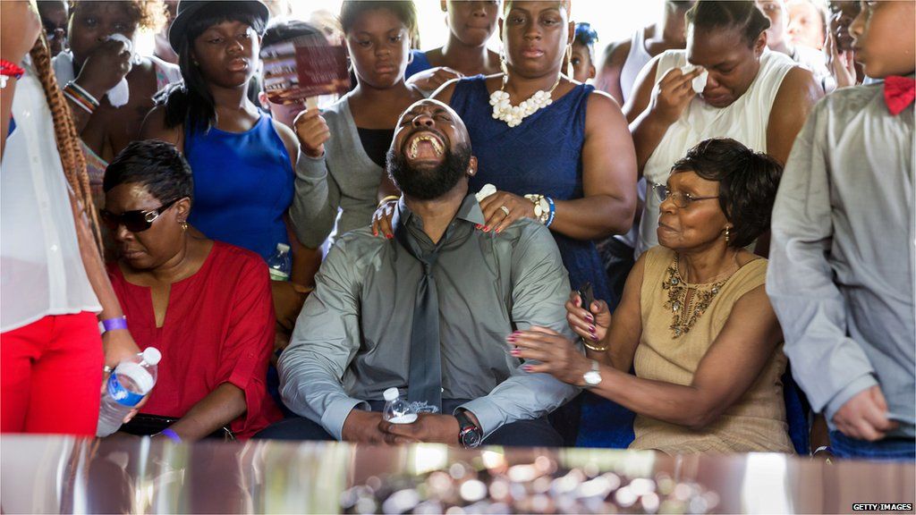Michael Brown Sr. yells out as the casket is lowered into the ground during the funeral for his son Michael Brown at St. Peters Cemetery on August 25, 2014