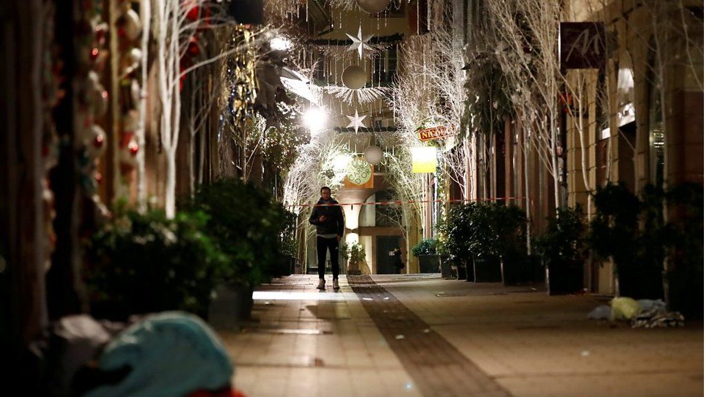 A man walks along a deserted Rue des Orfevres after a shooting in central Strasbourg