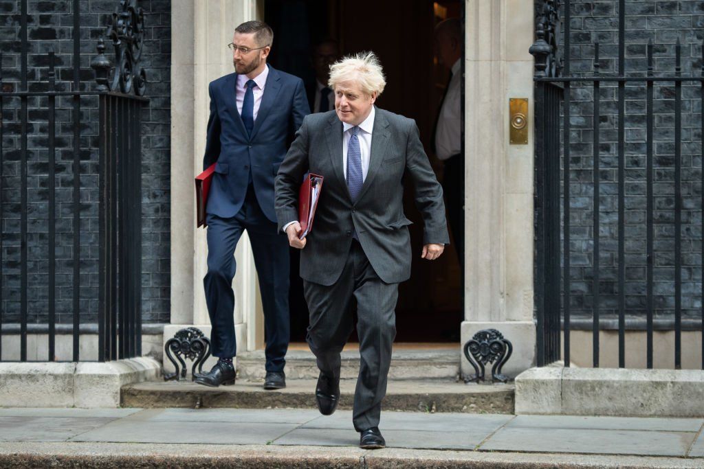 Simon Case, the head of the civil service, exiting Downing Street with Boris Johnson in 2020