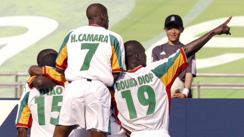 Salif Diao (left), Henri Camara (centre) and Papa Bouba Diop celebrate a goal at the 2002 World Cup