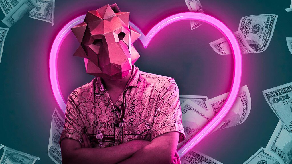 Man in pig mask with neon heart in background