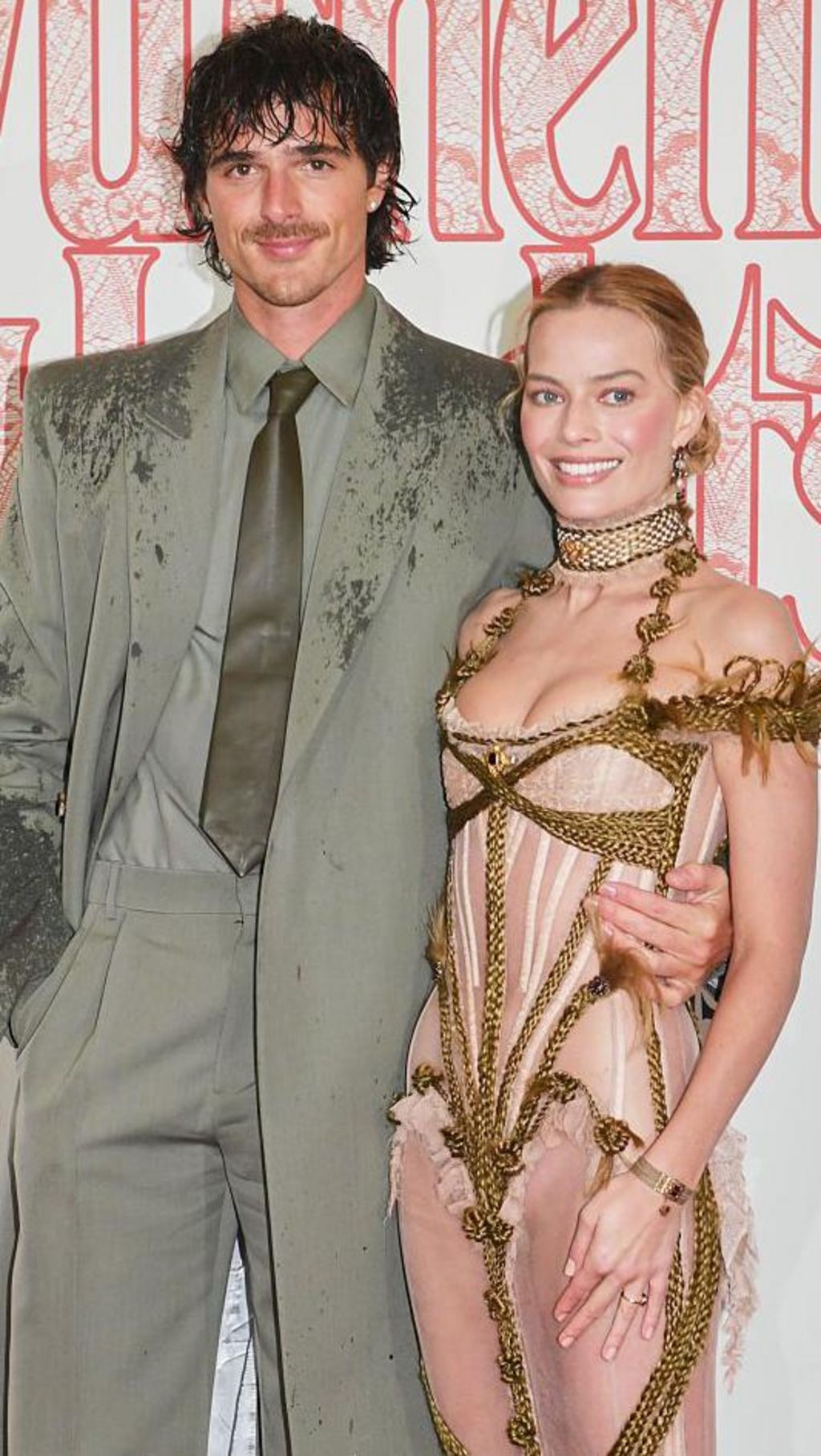 Jacob Elordi and Margot Robbie pose next to each other at the premiere. 