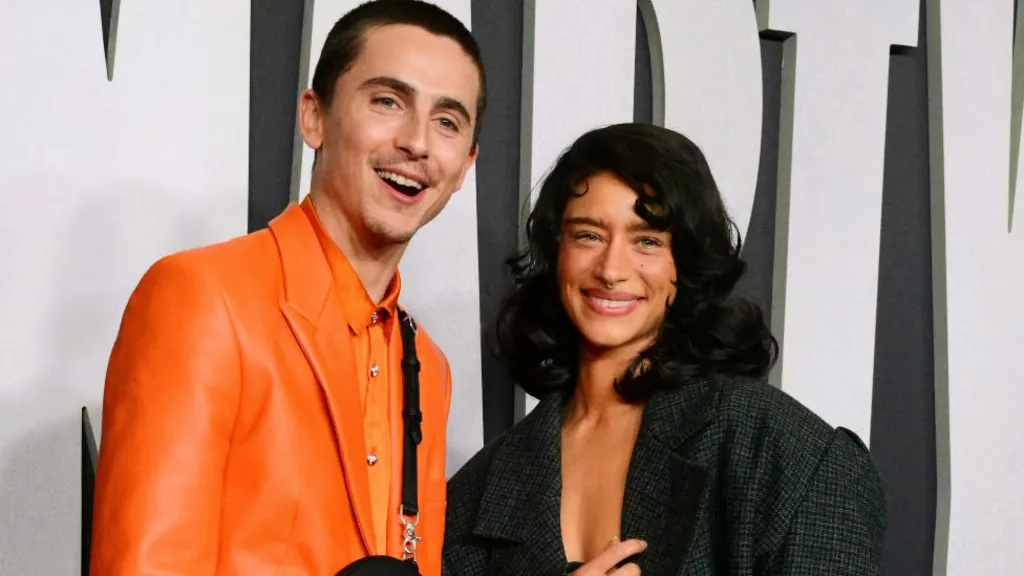 US-French actor Timothee Chalamet (L) and US-German actress Odessa A'zion attend the premiere of Marty Supreme in Los Angeles, California, on December 8, 2025.
