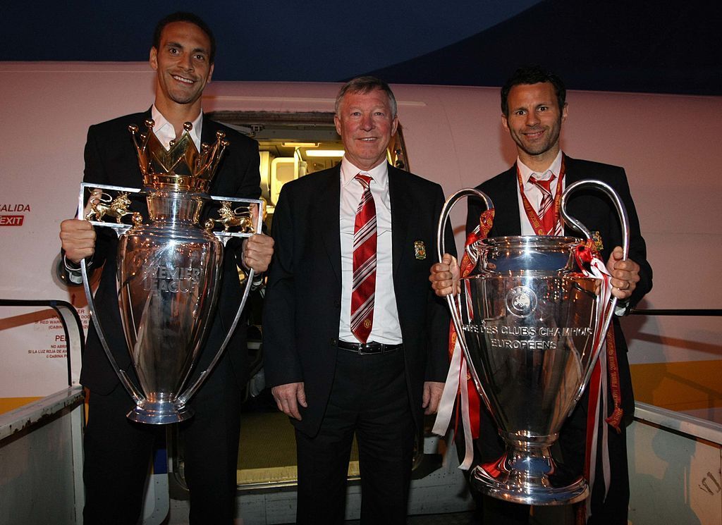Sir Alex Ferguson, Rio Ferdinand and Ryan Giggs proudly show off the Premier League and Champions League trophies