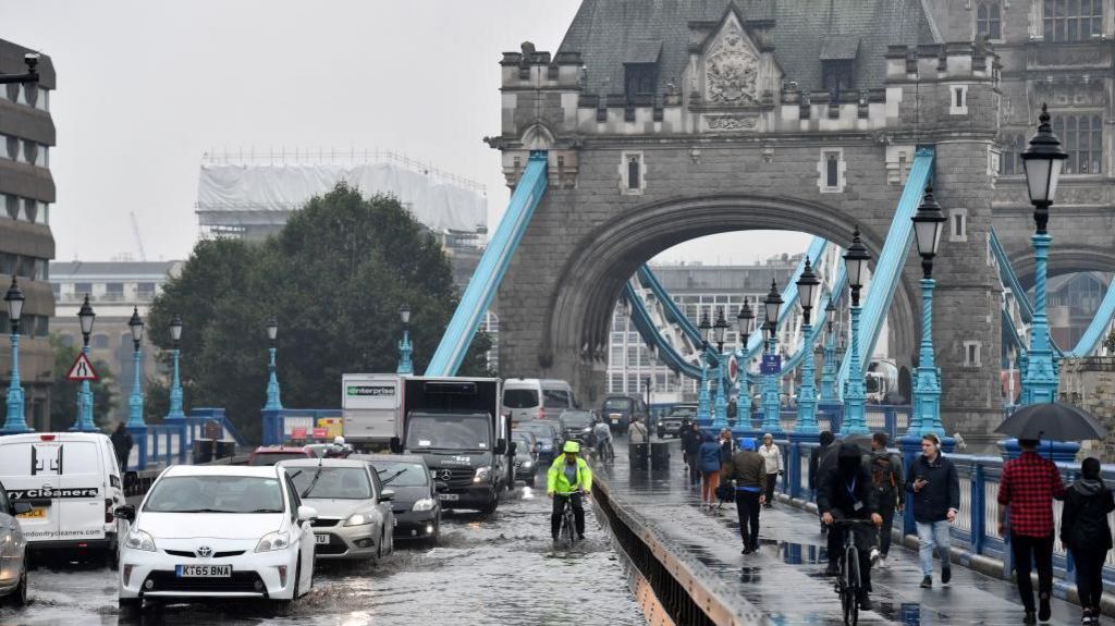 Tower bridge flooded with vehicles and cyclists across it