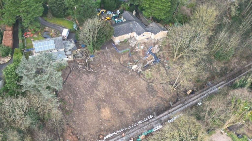 An aerial view of the landslip site with two houses which had to be demolished