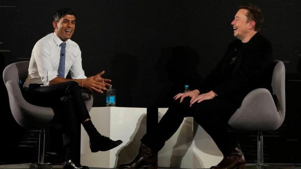 Former prime minister Rishi Sunak laughs with Elon Musk as both men talk at an event last year