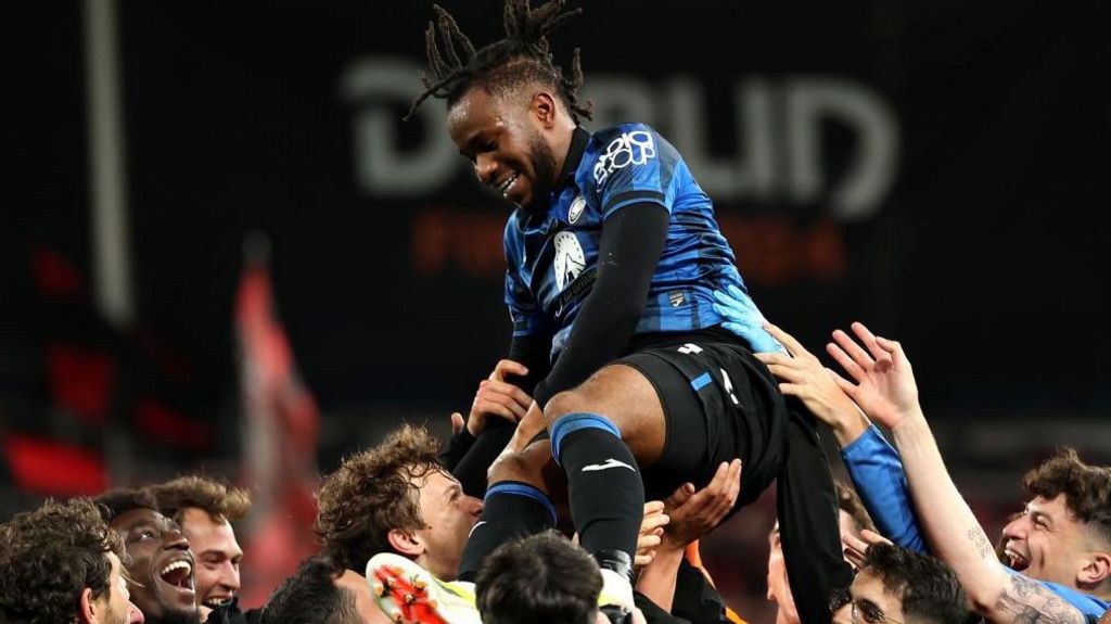 Atalanta players lift Ademola Lookman up in celebration