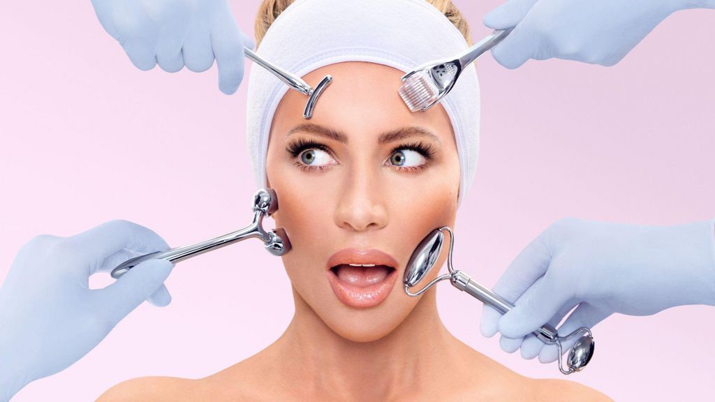 Picture of Olivia Attwood with beauty devices on her face and a shocked expression