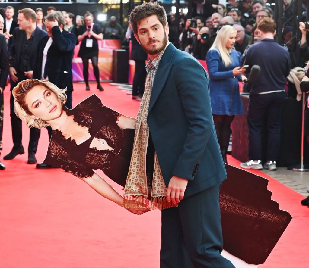 Andrew Garfield (R) poses with a cardboard cutout of Florence Pugh at the Headline Gala screening of "We Live In Time" during the 68th BFI London Film Festival at The Royal Festival Hall on October 16, 2024 in London, England