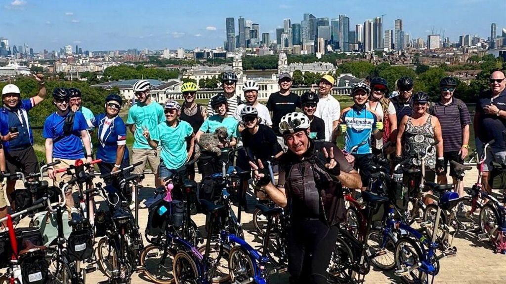 Nico Georgiou with other cyclists with London's skyline in the background