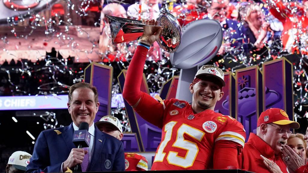 Patrick Mahomes lifting the Super Bowl trophy in Las Vegas