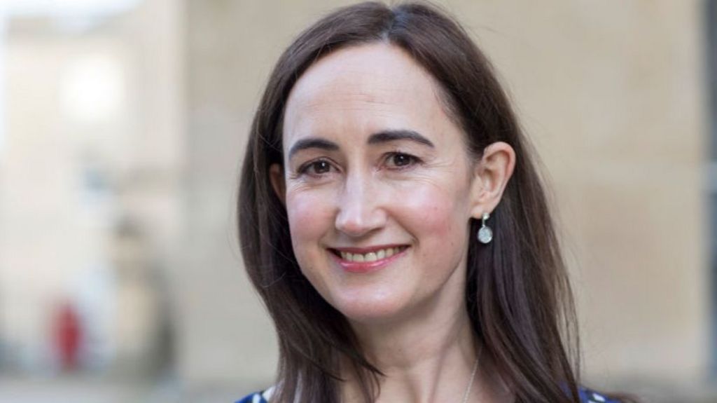 Sophie Kinsella pictured smiling at the camera. Her long brown her has been styled down in this image. 