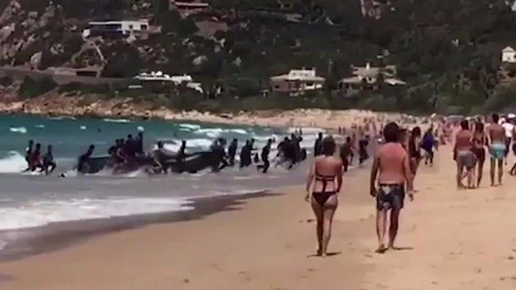 Migrants arrive on Playa de los Alemanes in southern Spain
