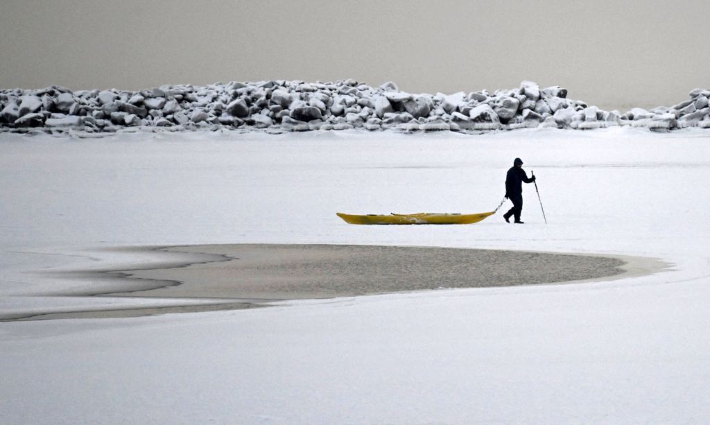 A man walks on the frozen sea in Helsinki, Finland.
