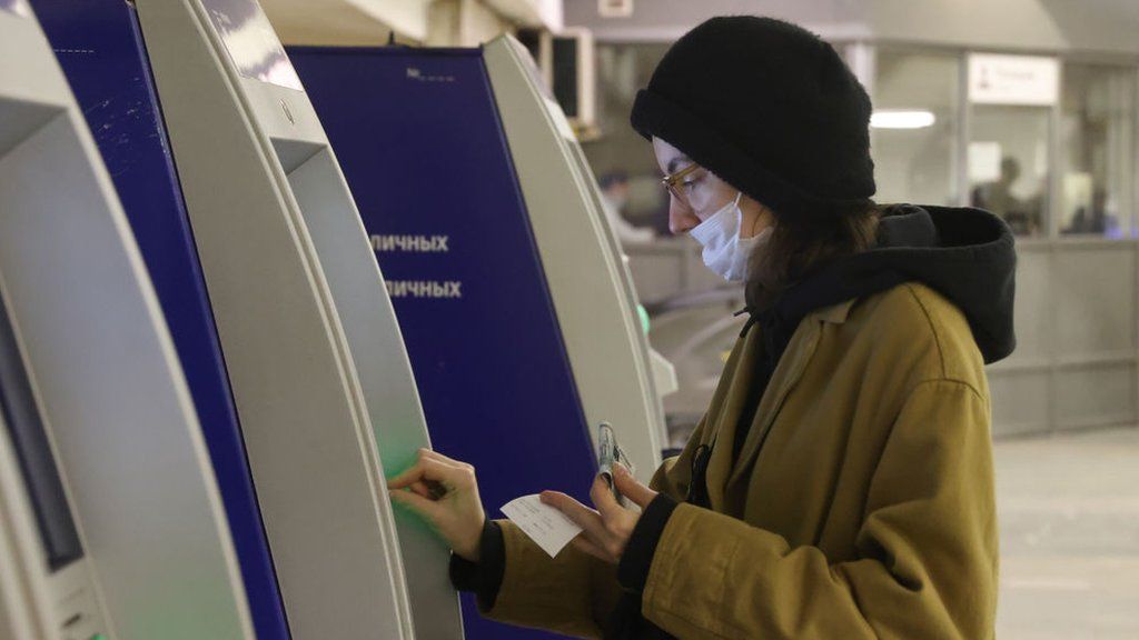 Woman using an ATM in Moscow
