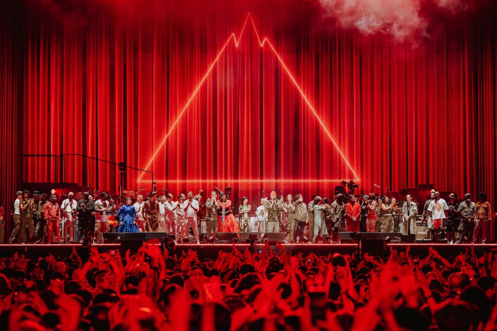 The performers at Gorillaz' stadium show line up for a curtain call