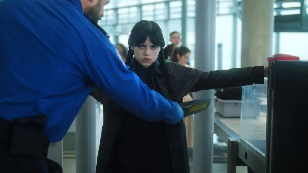 The trailer sees Wednesday having to unload her weapon-filled bag as she goes through security