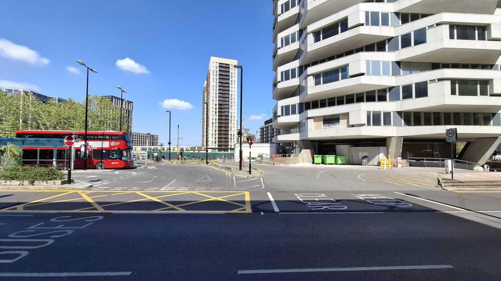 The new road markings with half of the road covered by a yellow box and the other side with a white keep clear box.