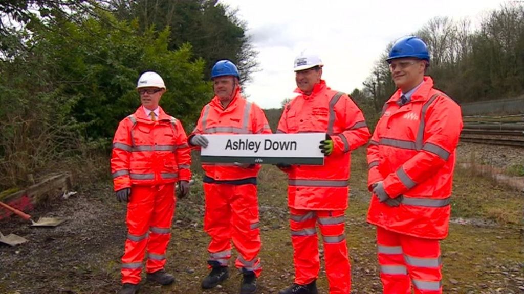Workers hold Ashley Down sign