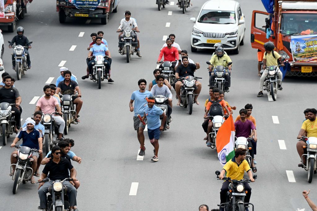 On the day of Shivratri, Kawariya carrying Dak Kavad on Sector 95 Road, on July 15, 2023 in Noida, India.