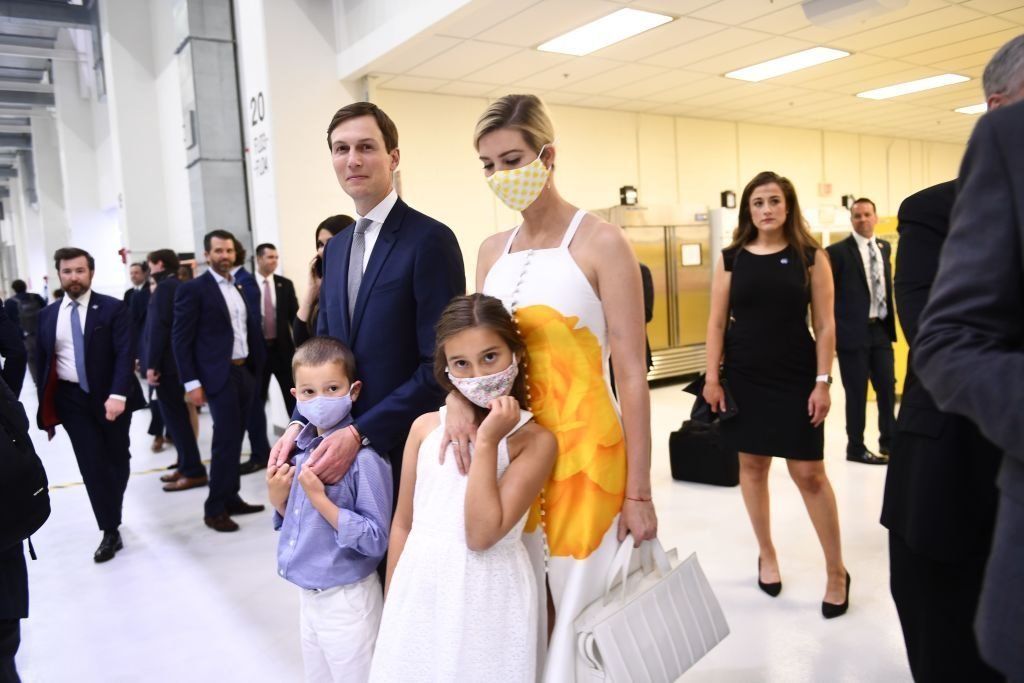 An unmasked Jared Kushner alongside a masked Ivanka Trump and their kids during a public appearance