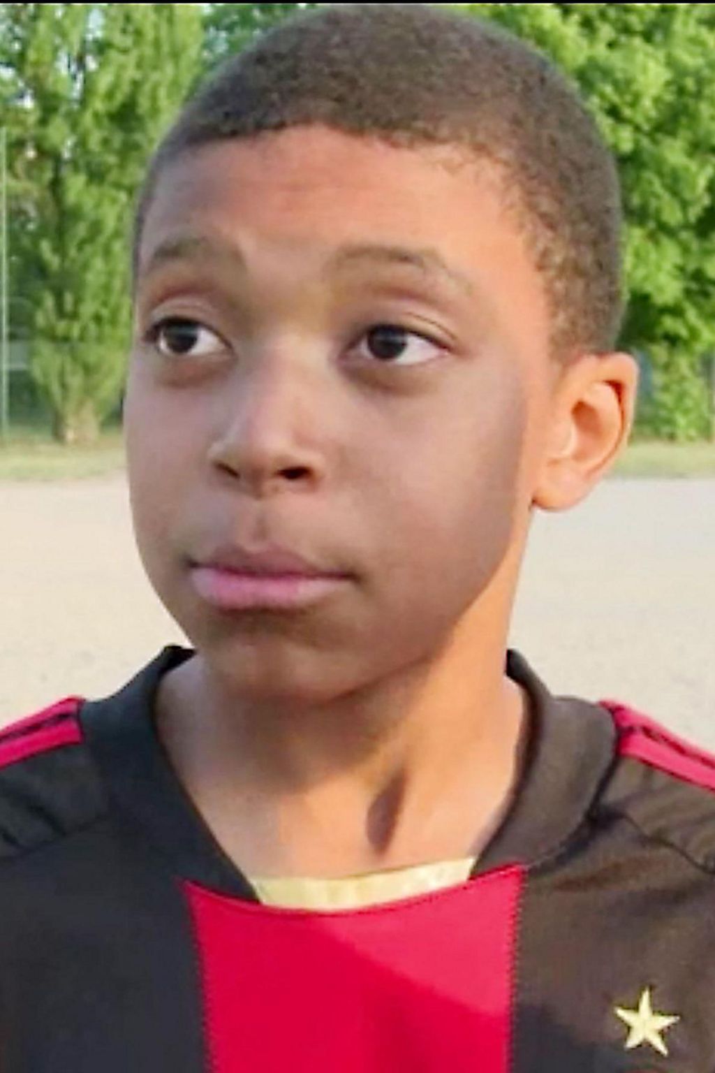 A 12-year-old Kylian Mbappe in an AC Milan shirt