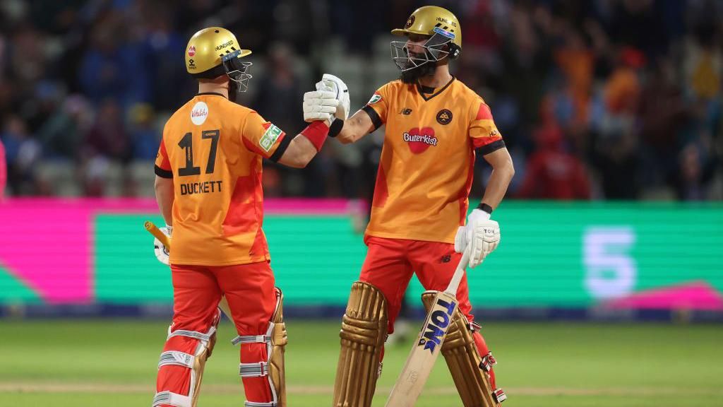 Birmingham Phoenix batters Moeen Ali (left) and Ben Duckett (right) bump gloves after beating Manchester Originals in The Hundred