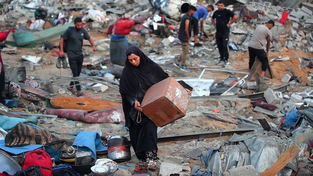 Palestinians in Gaza retrieve belongings after Israeli air strike