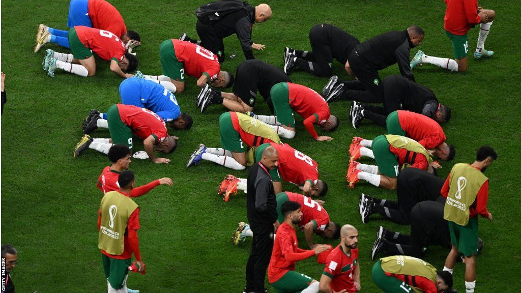 Morocco players praying on the pitch after the final whistle