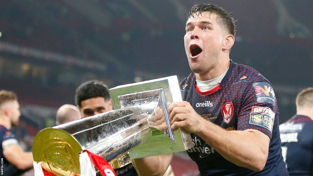 St Helens prop Louie McCarthy-Scarsbrook prepares to lift the Super League trophy in front of the fans