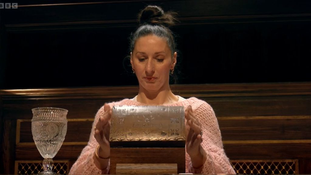 Rachel opening her chest of chance at the roundtable and looking inside