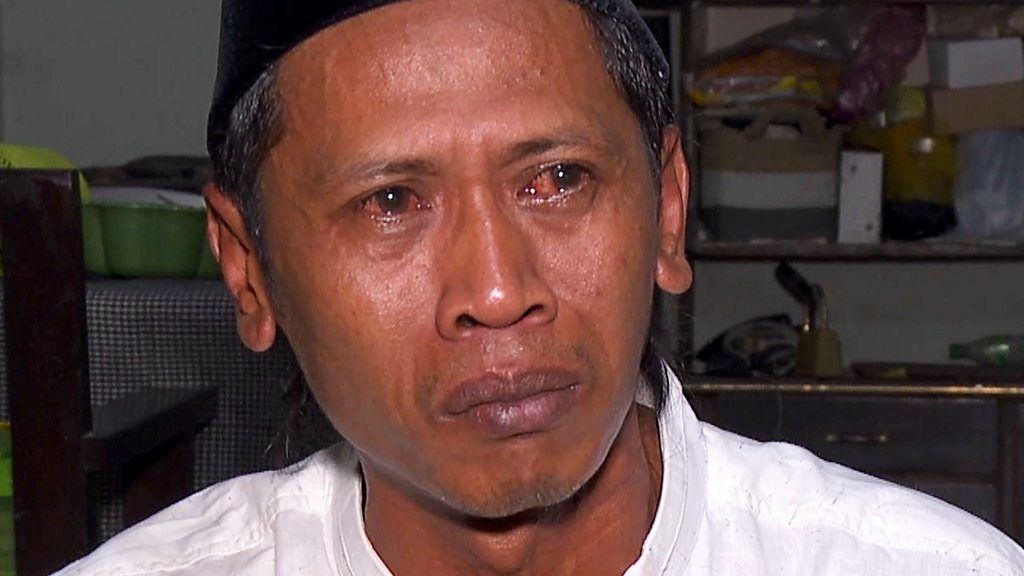 A close-up of a man from Indonesia with tears in his eyes