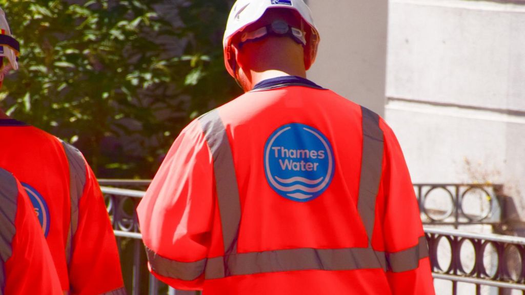A man wearing high-viz clothing with the Thames Water logo on the back.